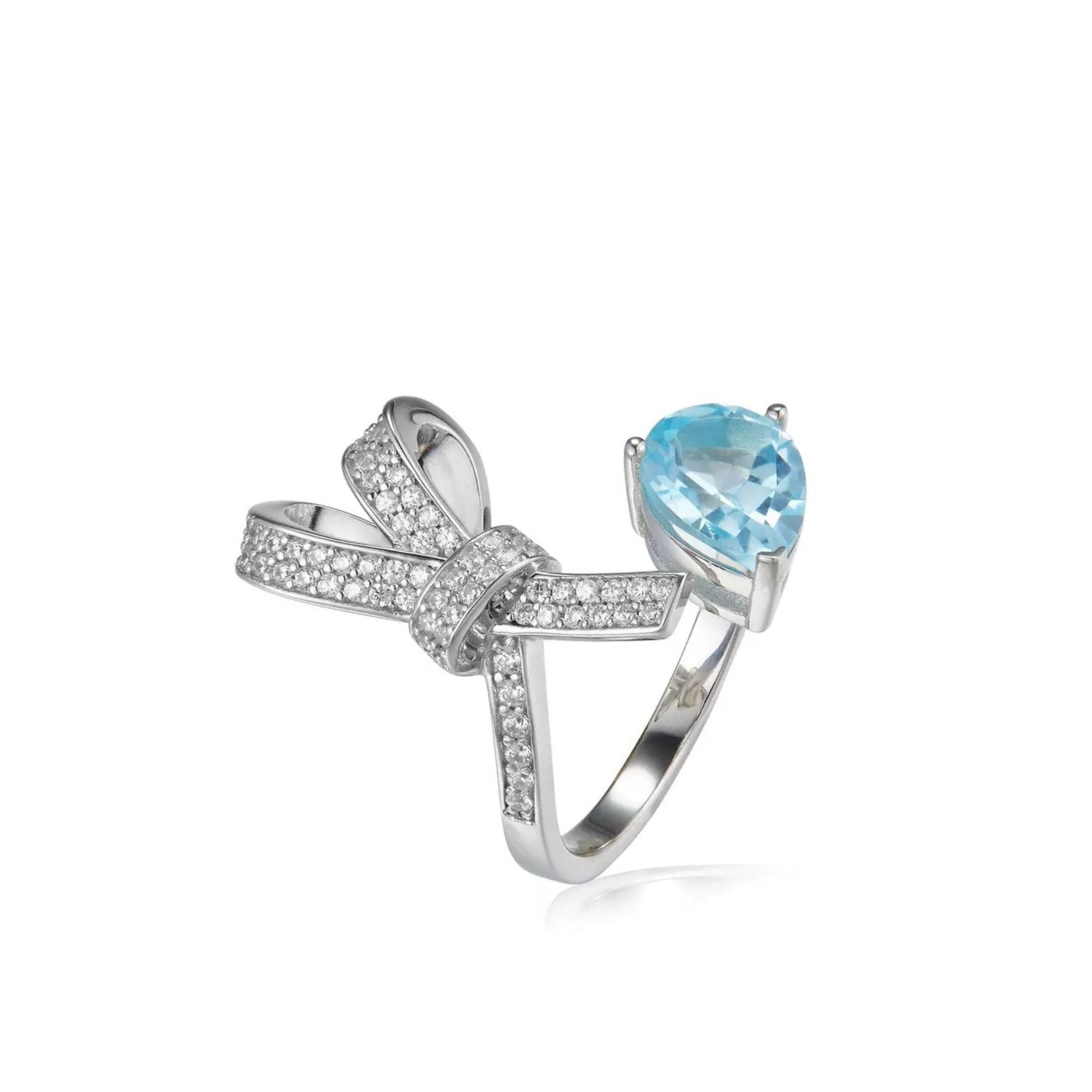 Awakened TIme Bleu Ruban adjustable open ring in 18ct white gold vermeil featuring a pear-cut natural blue topaz and sparkling pavé zirconia bow design.
