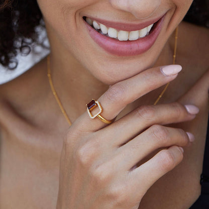 Close-up of the Carré Rouge Ring on hand, highlighting the natural red garnet stone and refined gold vermeil setting.