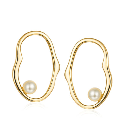 Pair of Contour d’Or Pearl Earrings in 18k gold vermeil featuring fluid, organic gold loops encircling a suspended pearl.