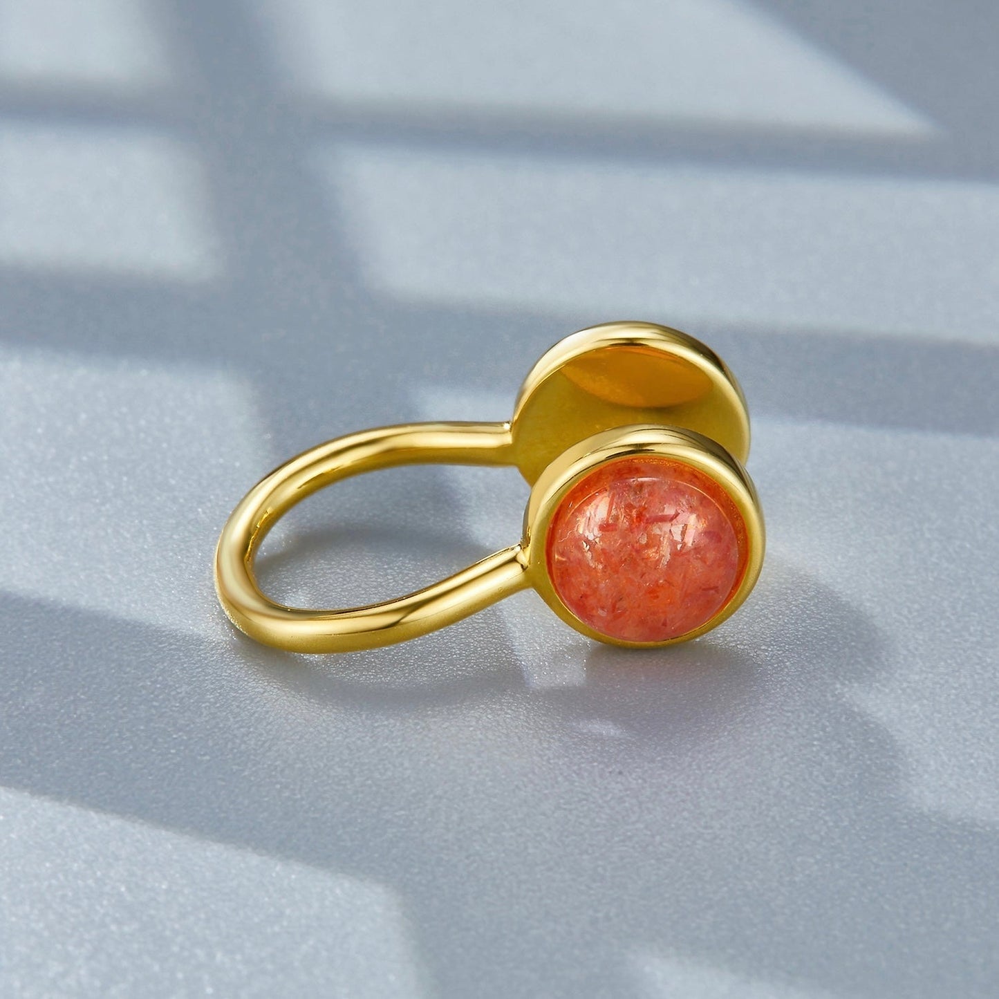 Studio detail view of the Gemini gold ear cuff showcasing the warm, glittering sunstone gem.