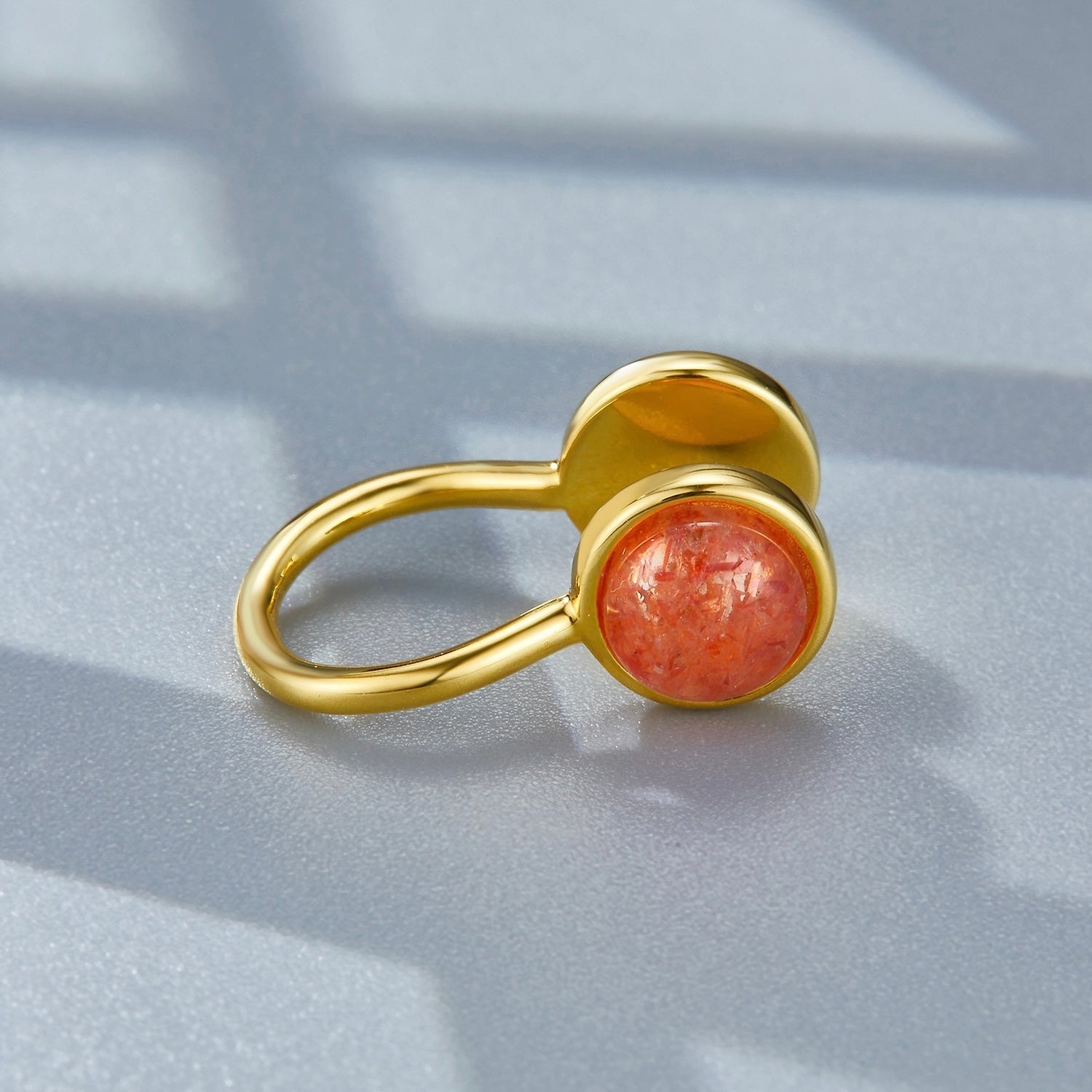 Studio detail view of the Gemini gold ear cuff showcasing the warm, glittering sunstone gem.