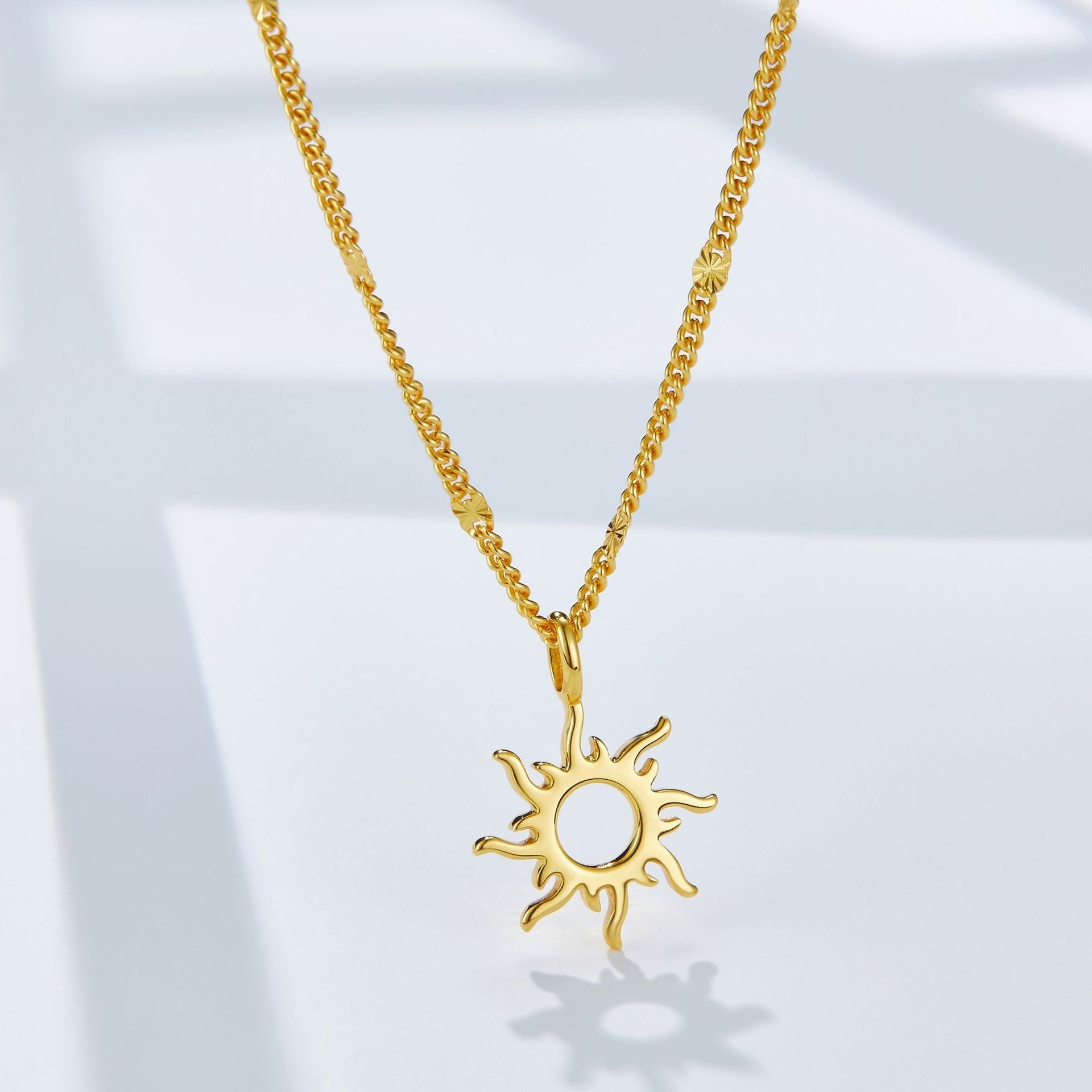 Full view of the Helia gold vermeil sunburst pendant necklace on a clean white surface