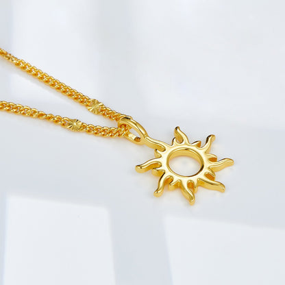 Close-up of the sunburst Helia pendant in 18ct gold vermeil on a light background