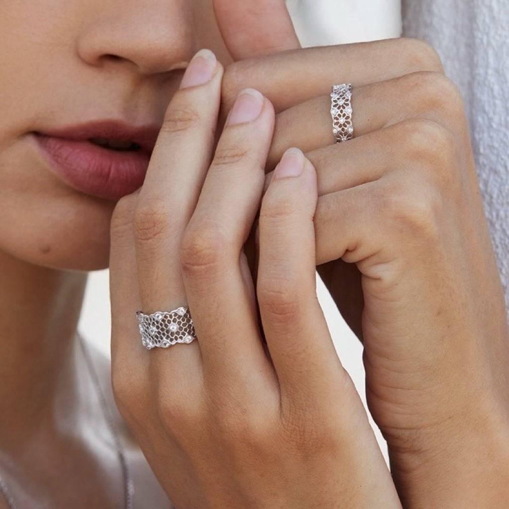 Awakened Time Iceveil Band in 18ct white gold vermeil, featuring an intricate Parisian-inspired lace filigree design worn on the hand.