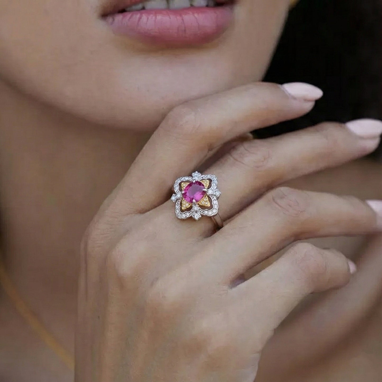 Awakened Time La Rosa di Firenze dual-tone gold vermeil and garnet ring styled on a hand, highlighting its Renaissance-inspired floral silhouette.