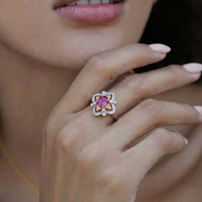 Awakened Time La Rosa di Firenze dual-tone gold vermeil and garnet ring styled on a hand, highlighting its Renaissance-inspired floral silhouette.