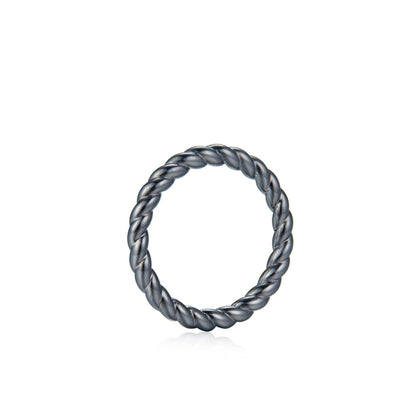 Awakened Time Léa Twist luxury ring in a clean studio product shot, showcasing its polished braided rope design crafted in 18ct recycled black gold plating.