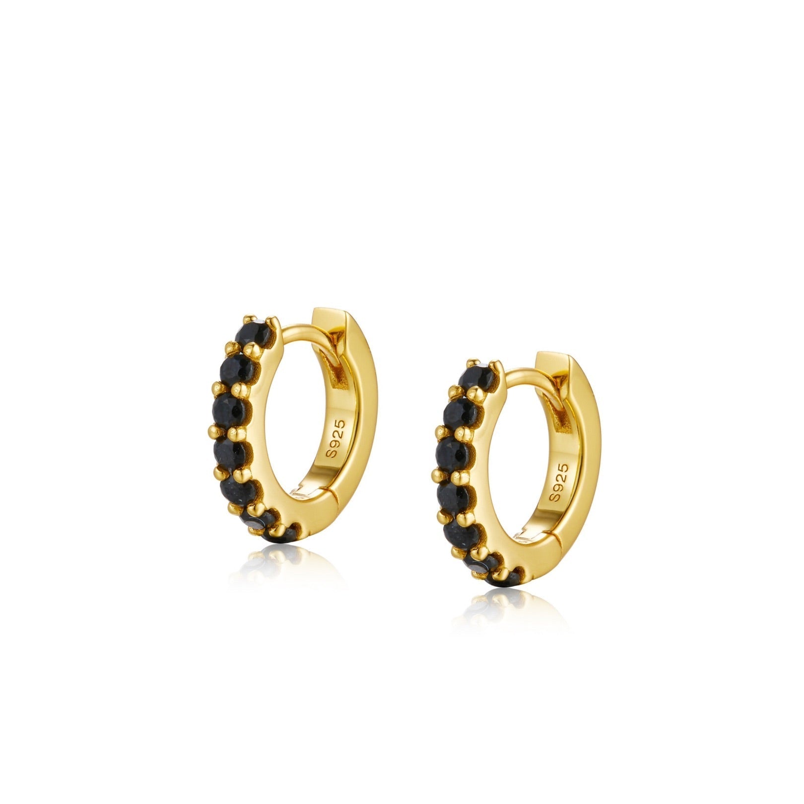 Pair of gold Noir Éclat huggie hoop earrings encrusted with round black zirconia stones.