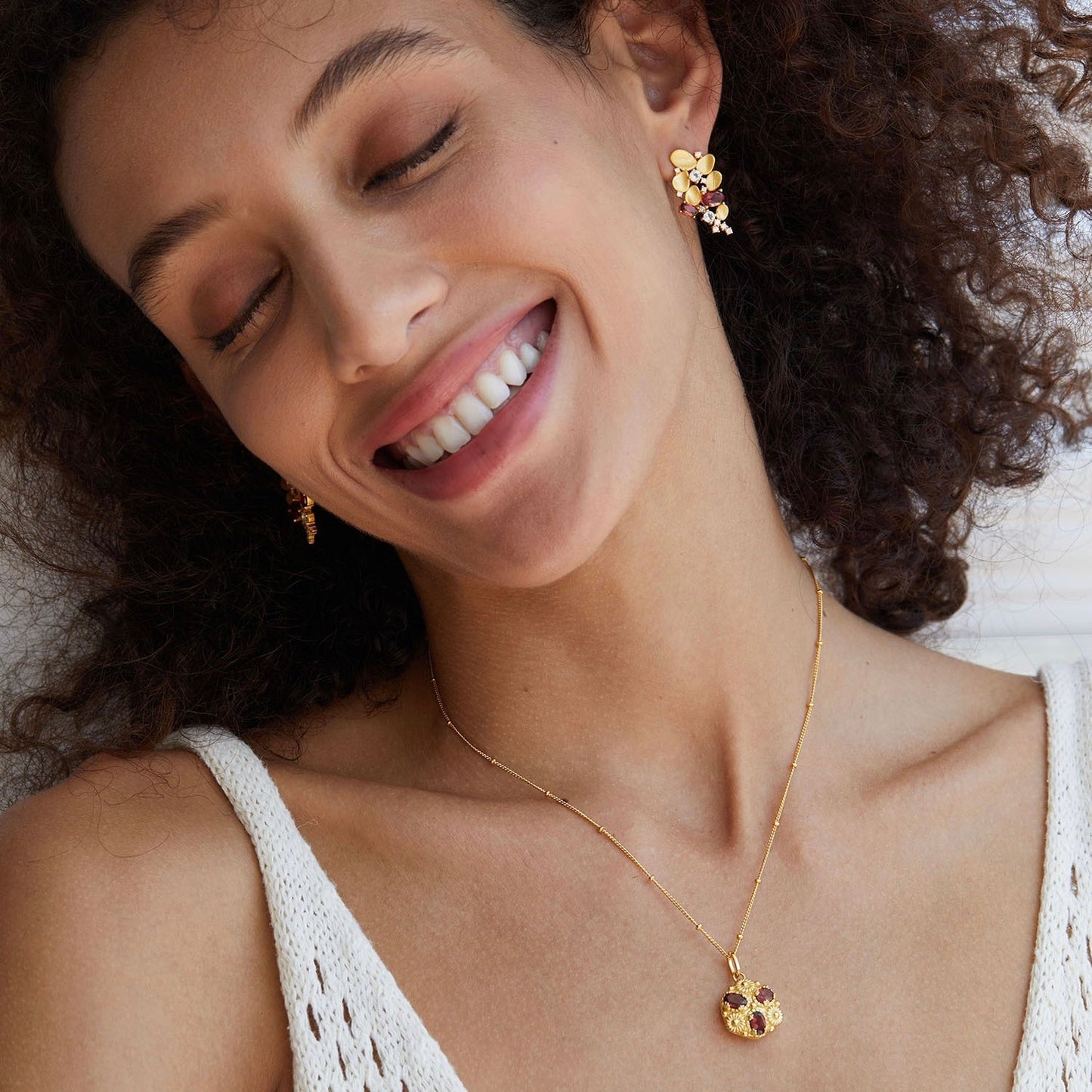 Model wearing the sculptural Opéra de Feu gold vermeil cascade earrings.