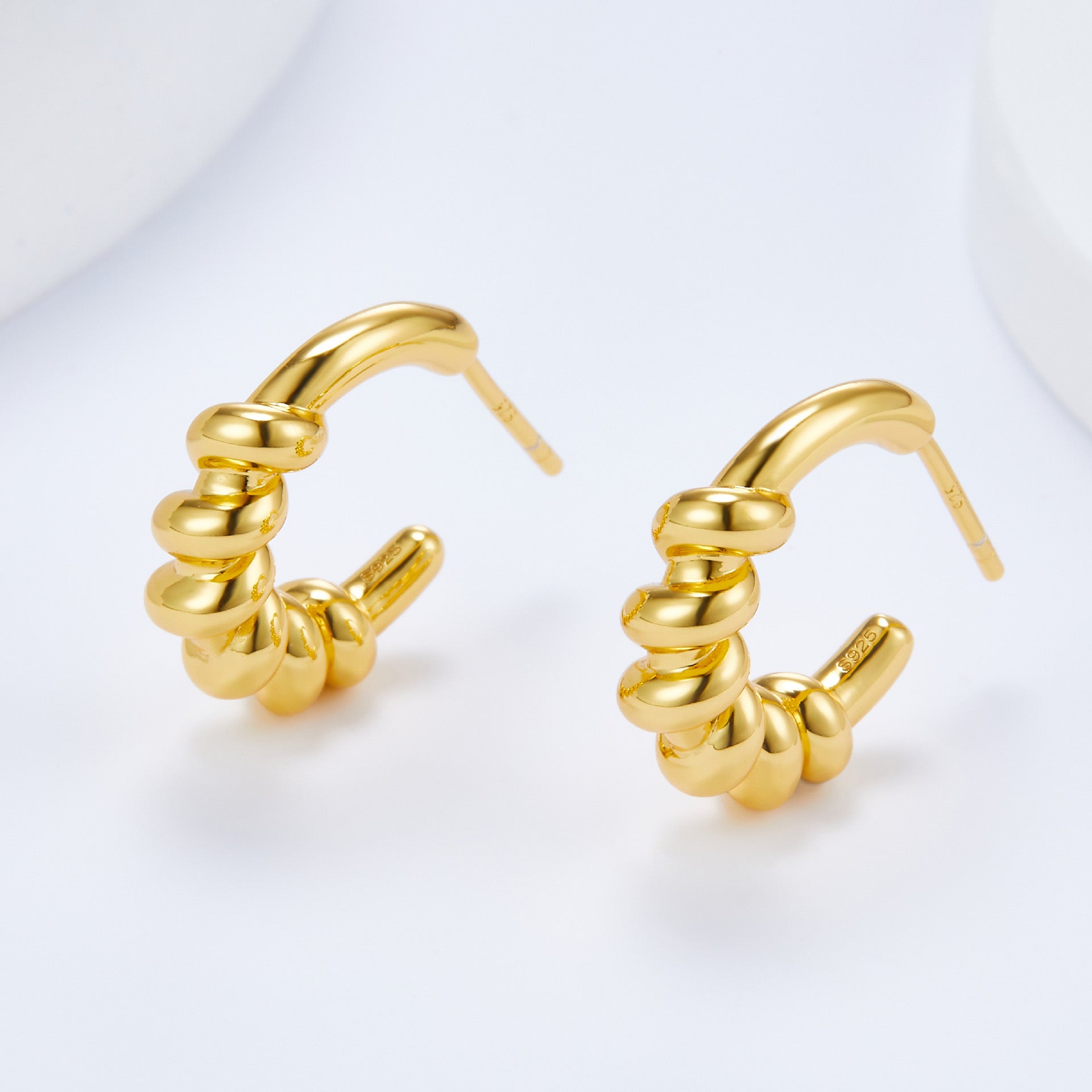 Pair of Roma Twist 18k gold vermeil rope hoop earrings displayed on a white background.
