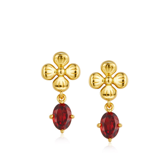 Pair of Rouge Fleur gold floral drop earrings featuring a four-petal botanical design and an oval red garnet dangle.